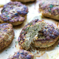 Oven Baked Turkey Zucchini Burgers Recipe. Golden brown, made with grated zucchini. Topped with chopped dill.