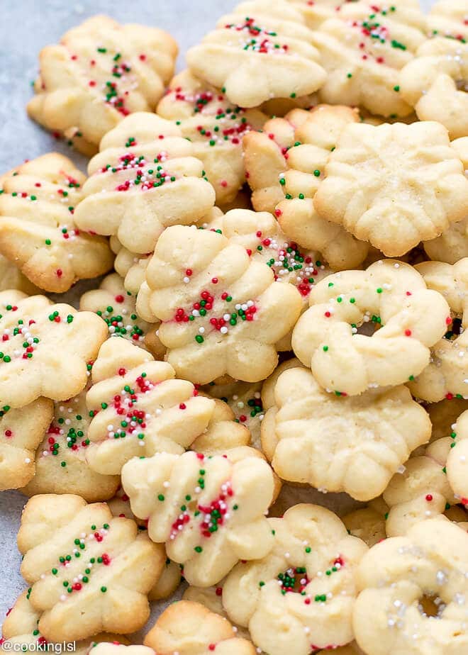 Easy Cream Cheese Spritz Cookies Recipe , baked to perfection in Christmas, holiday shapes. Topped with sprinkles. 