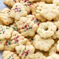 Easy Cream Cheese Spritz Cookies Recipe , baked to perfection in Christmas, holiday shapes. Topped with sprinkles.