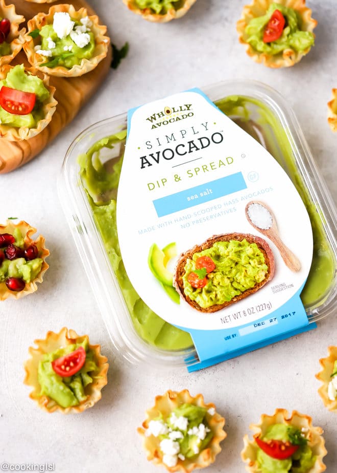 Avocado Filo Cups - Simply Avocado Wholly Guacamole dips, filo shells filled with avocado on a cutting board.