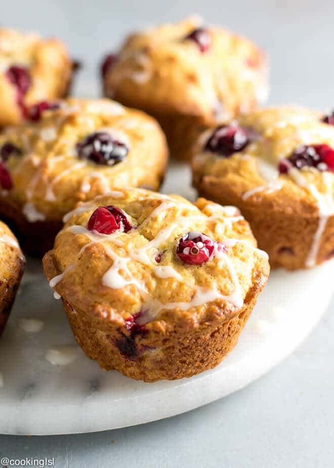 Healthy Cranberry Orange Muffins Recipe Refined Sugar Free on a platter, with a glaze.