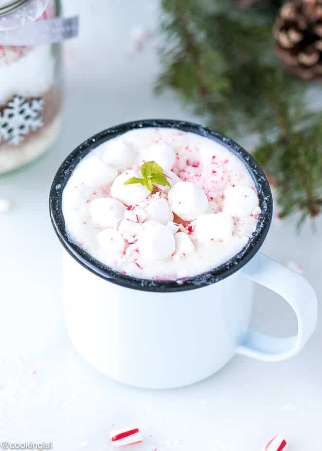 A cup of hot chocolate, topped with mashmallows and candy canes, mint extract, made with Hot Cocoa Mix In A Jar.