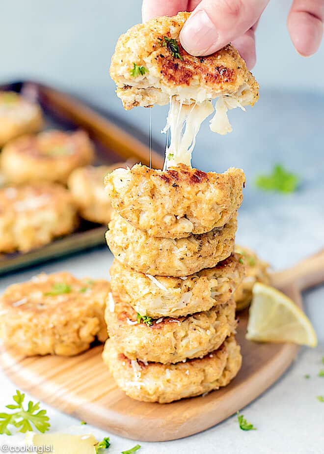 Cauliflower patties stacked on top of each other with a cheesy inside.