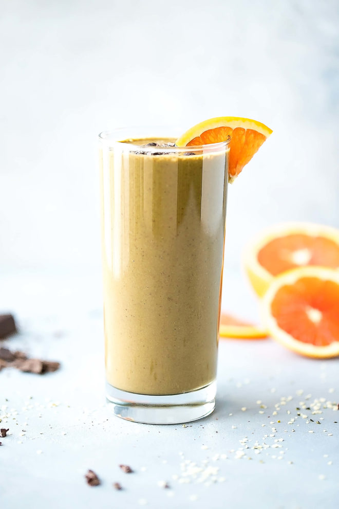 Chocolate orange smoothie in a glass with orange slice