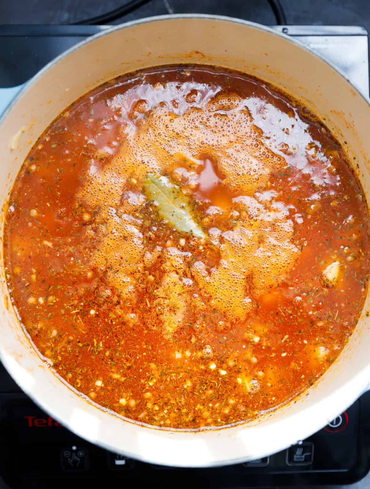 All ingredients for lentil and potato soup in a pot, before simmer.