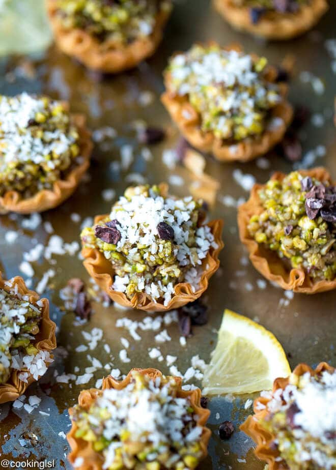 Cute, mini, holiday party baklava phyllo cups on a cookie sheet. Ready in 15 minutes with store bought frozen baklava cups.