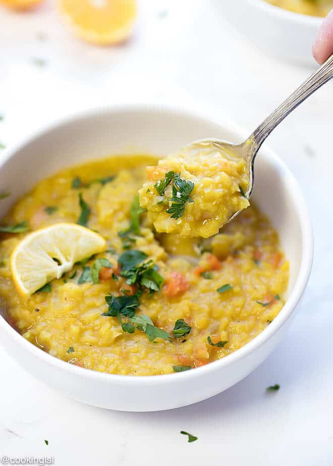Middle Eastern Lentil Soup Recipe, yellow color, topped with lemon.