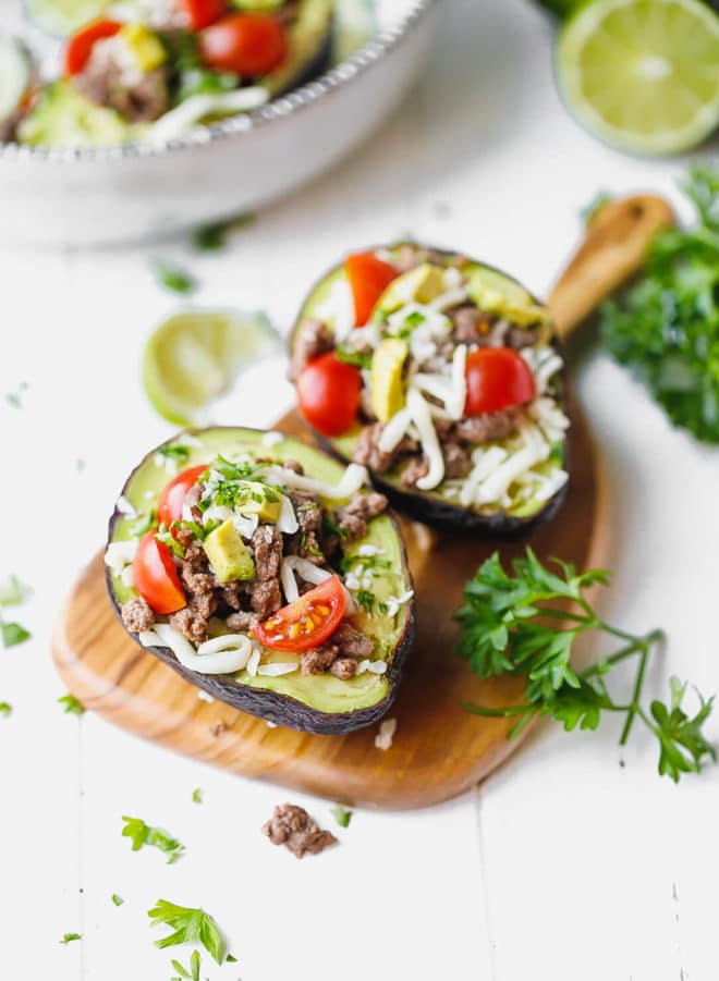 Taco Stuffed Avocado {Keto, Low-Carb} on a wooden board