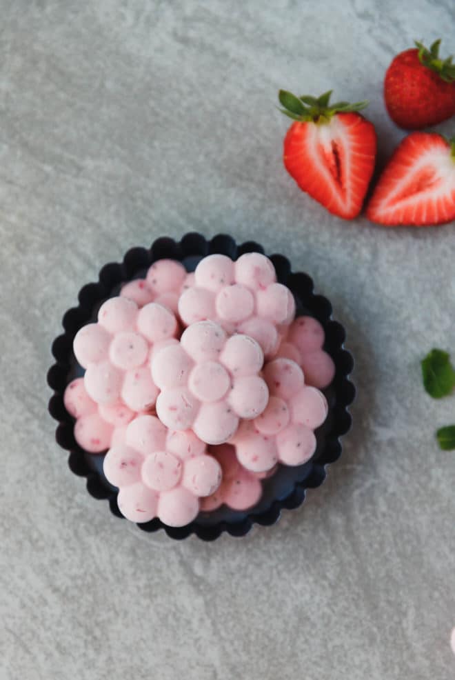 Keto Strawberry Fat Bombs in the shape of flowers in a serving dish