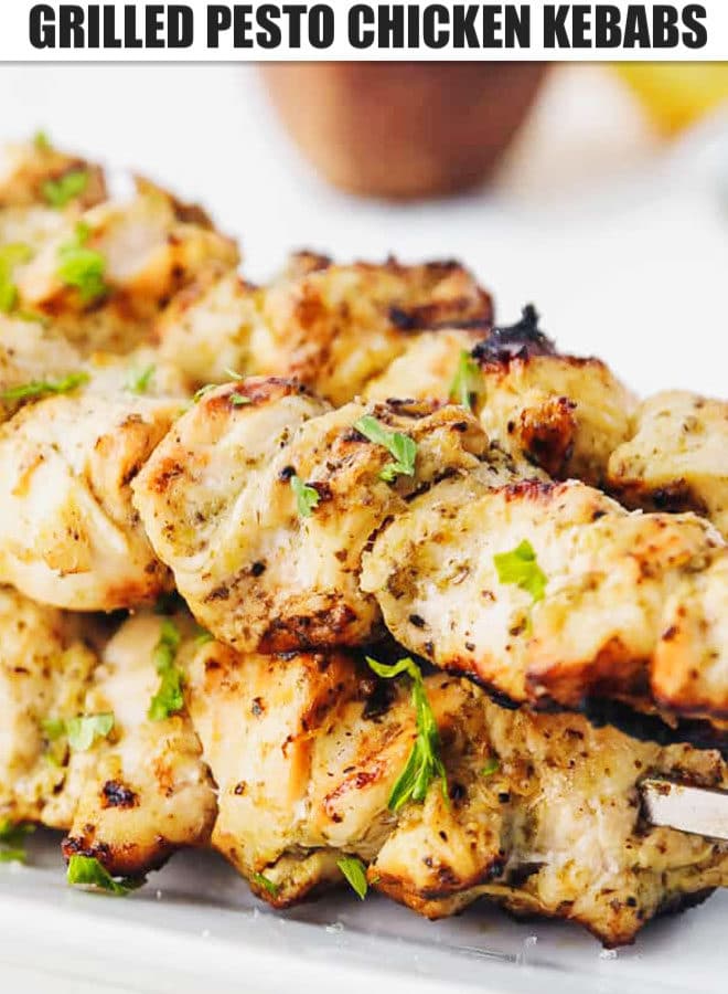 Grilled posto chicken kebabs on a white plate