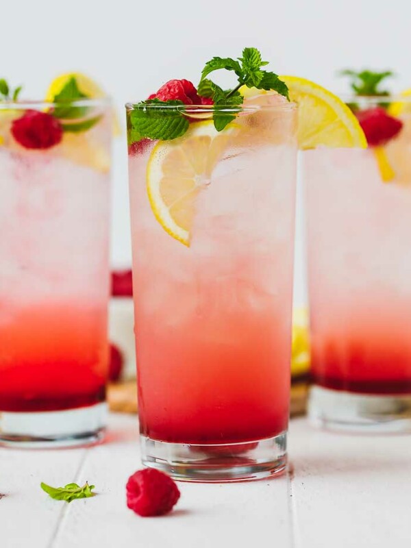 raspberry lemonade in three clear tall glasses