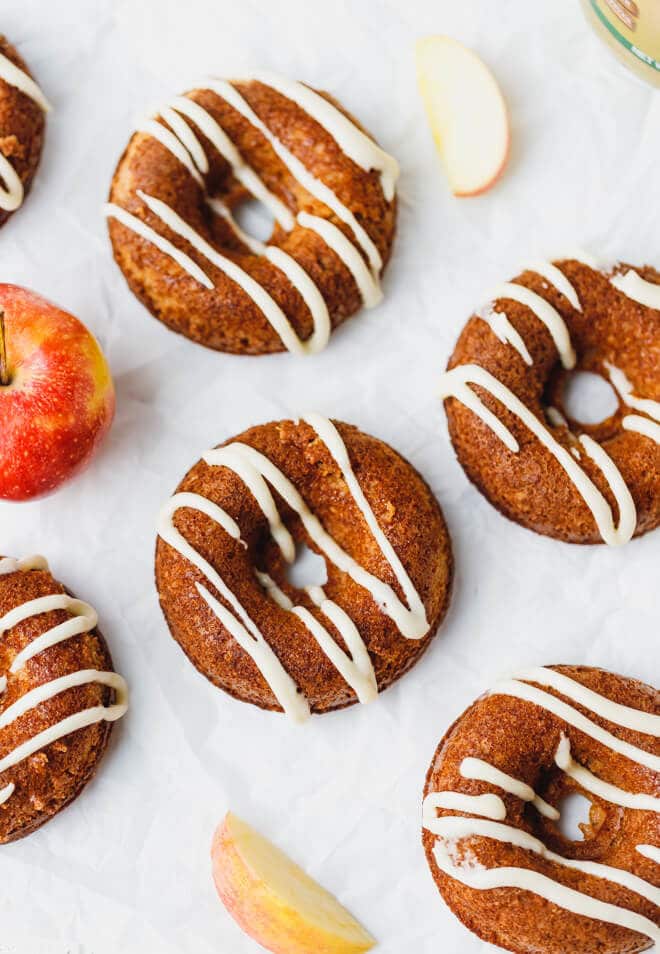 Apple donuts with glaze on parchment paper