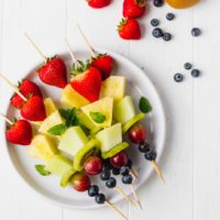 Fruit skewers on a white plate