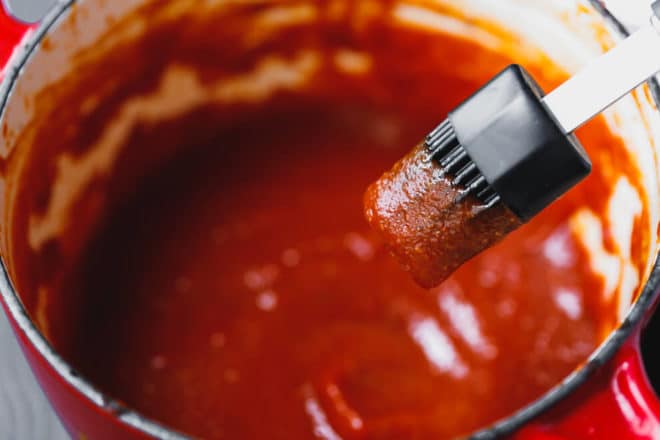 Keto Barbecue Sauce in a saucepan with a brush
