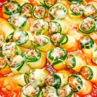 A white pan with zucchini lasagna roll ups