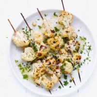 Grilled Cauliflower florets on a skewer on a plate