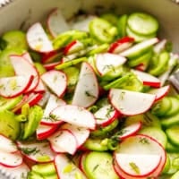 close up cucumber radish salad with dill and sliced cucumbers and radishes