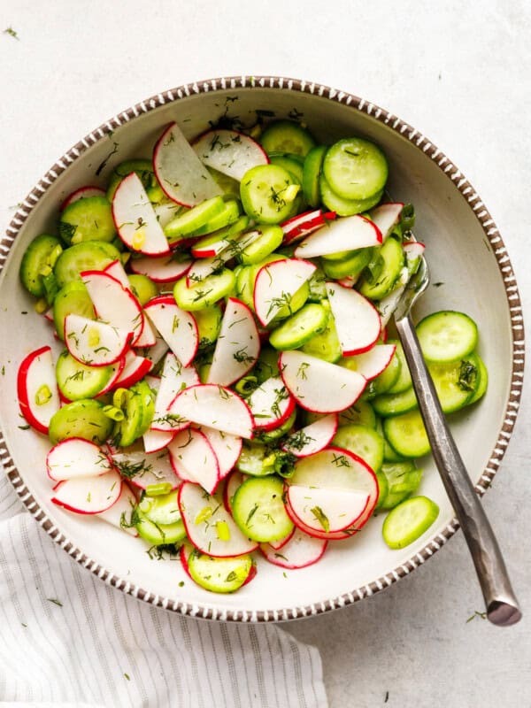 cucumber radish dill salad top view with sliced cucumbers radishes and green onions