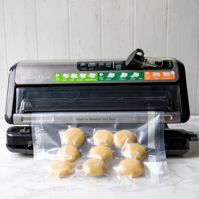 Low-carb sugar cookies unbaked in a bag being sealed with FoodSaver®