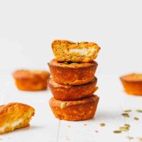 Low-carb pumpkin muffins with cream cheese center stacked on each other