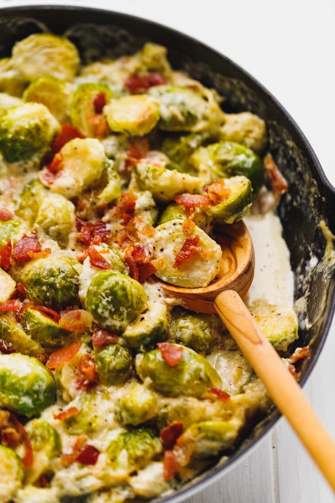 Cheesy Creamy Brussel Sprouts With Bacon in a skillet