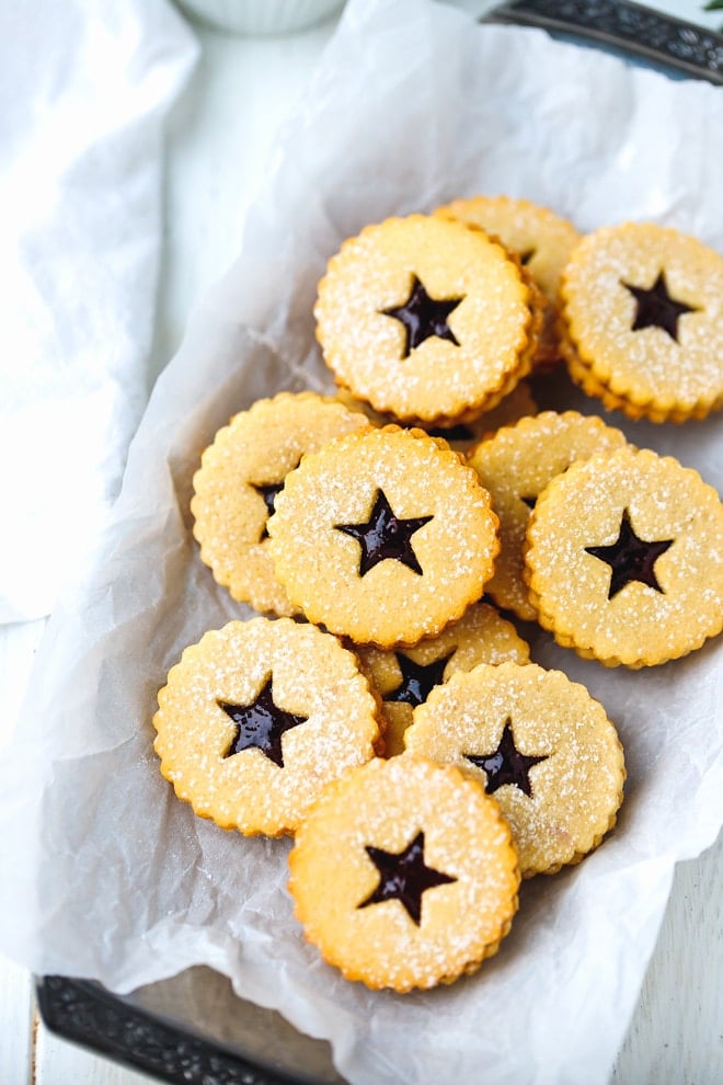 Keto linzer cookies on a parchment paper lined tray