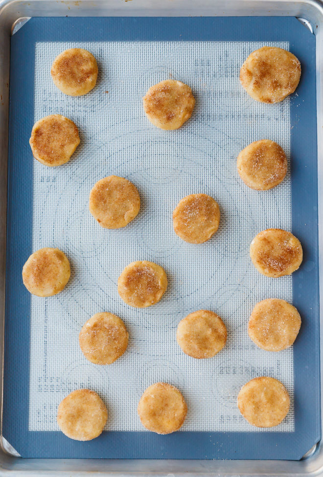 Unbaked snickerdoodle cookies on a baking sheet