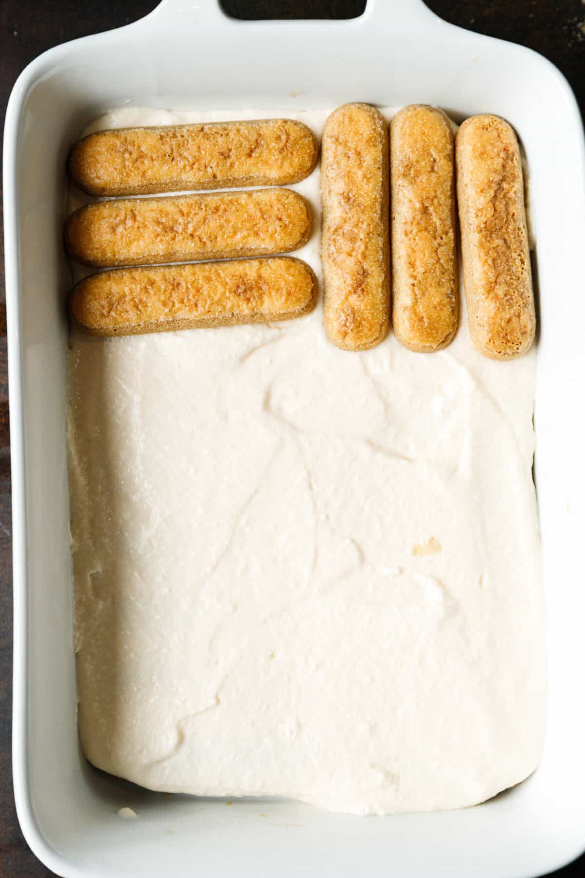 Second layer of soaked ladyfingers placed on top of mascarpone cream.