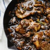 Pork steak with mushrooms and onions in a pan