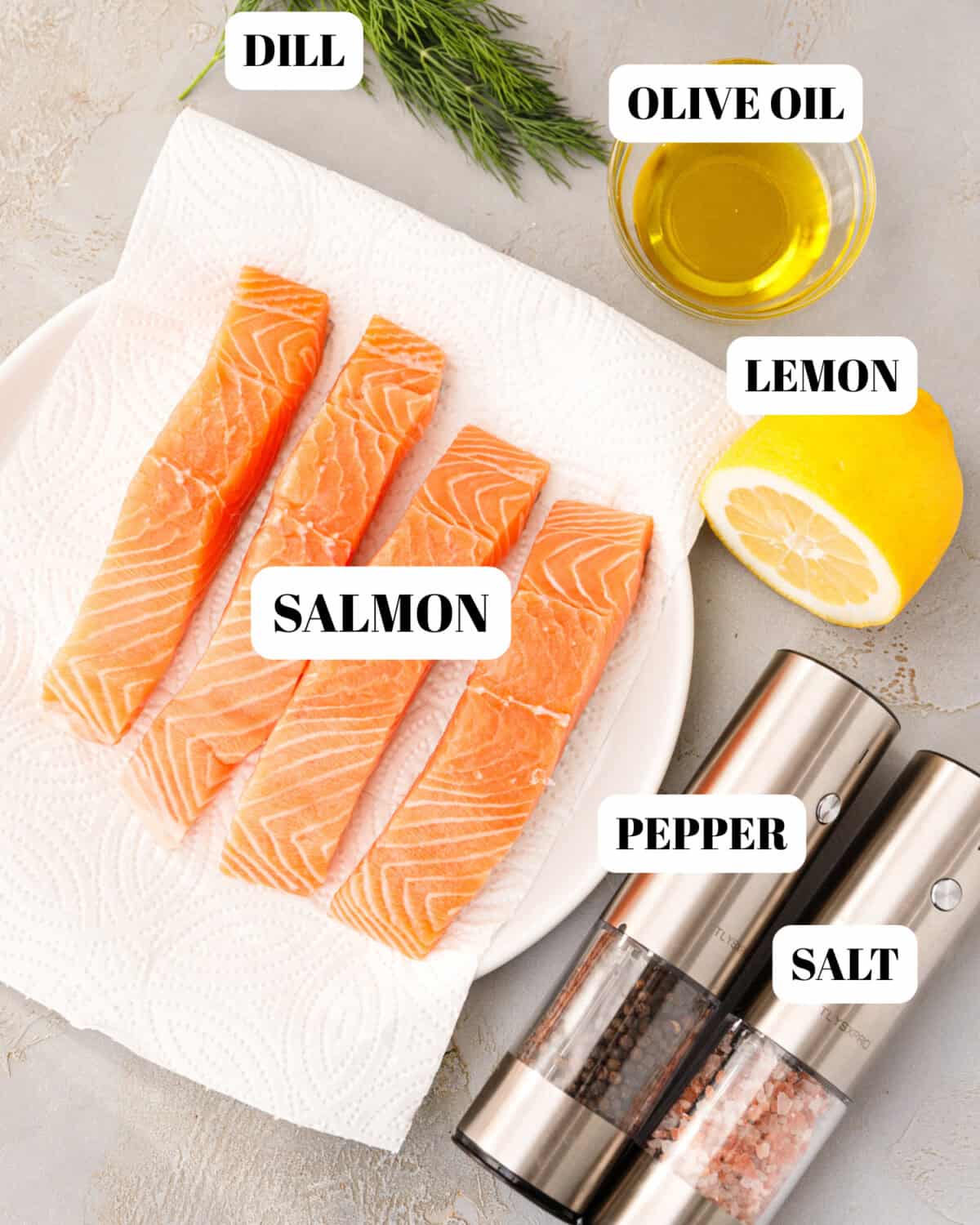 Pan seared salmon ingredients including fresh salmon fillets, olive oil, lemon, dill, salt and pepper