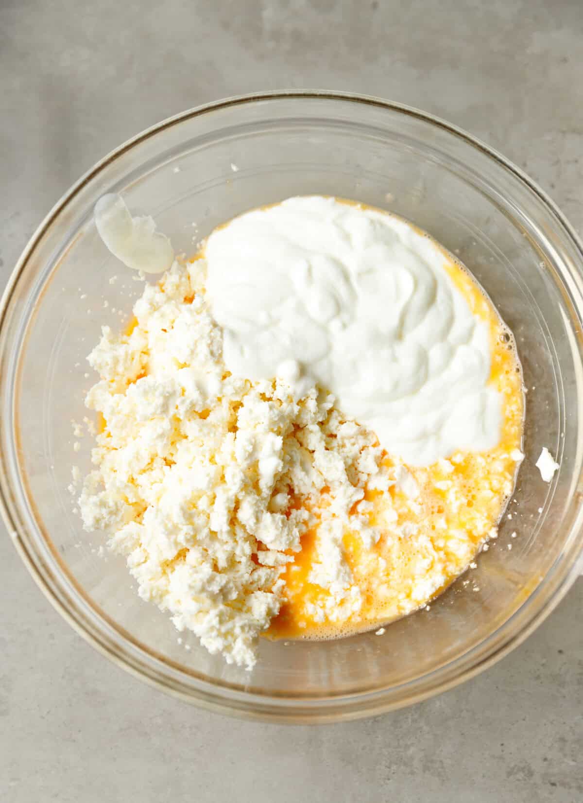 Eggs, feta cheese and yogurt mixed in a bowl to make the filling for Bulgarian banitsa