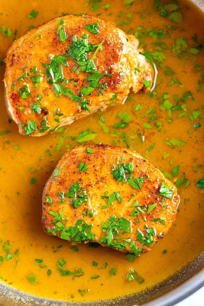 Juicy pork chops in a pan with sauce