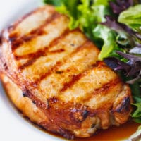 Grilled beer marinated pork chops on a plate