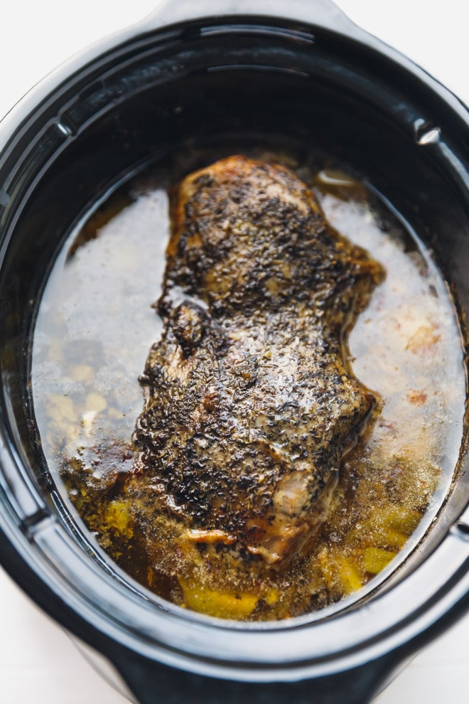 Slow cooked leg of lamb on a cutting board