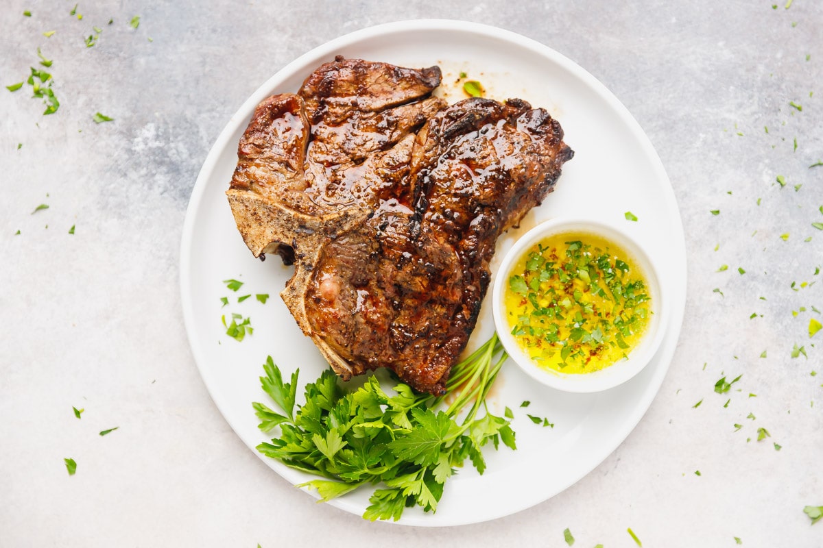 What is the ideal position to finish cooking a T-Bone steak on the grill?
