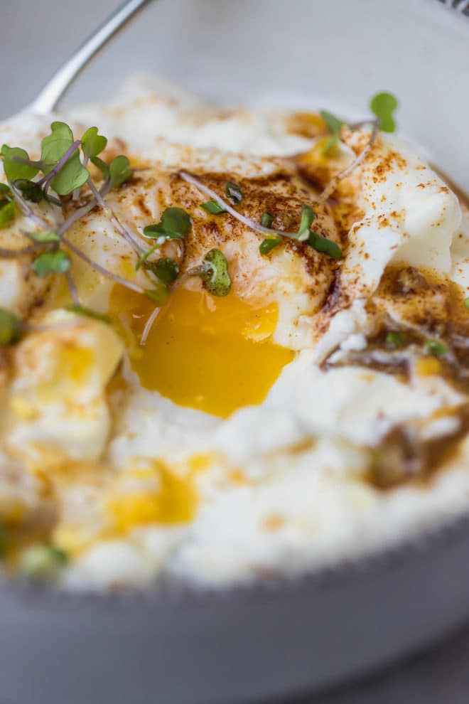 Poached eggs runny yolk over yogurt