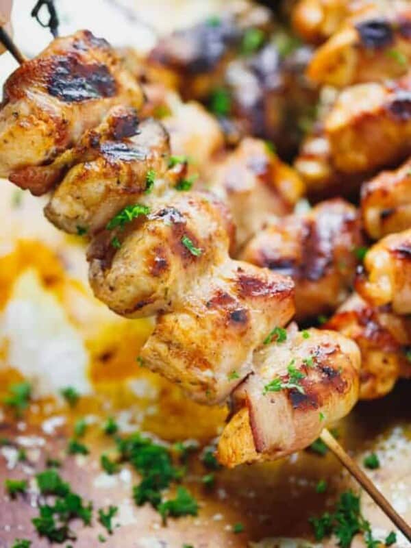 bacon wrapped chicken kebabs on a cookie sheet