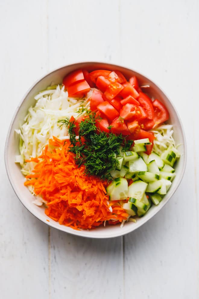 cabbage salad in a white bowl