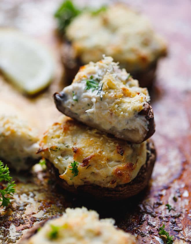 mushrooms stuffed with crab and parmesan on a baking sheet