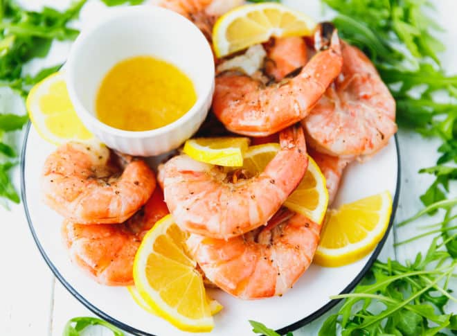 broiled jumbo shrimp on a plate with lemon