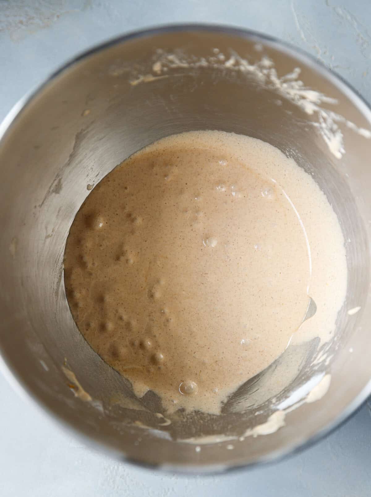 Pumpkin custard cake batter in a mixing bowl after combining pumpkin puree and spices, ready for the milk and egg whites.