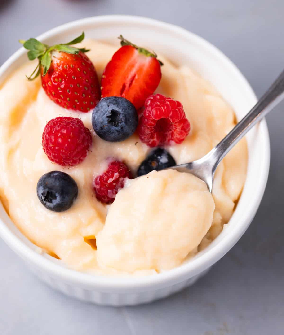 Spoonful of thick vanilla pastry cream showing creamy consistency.