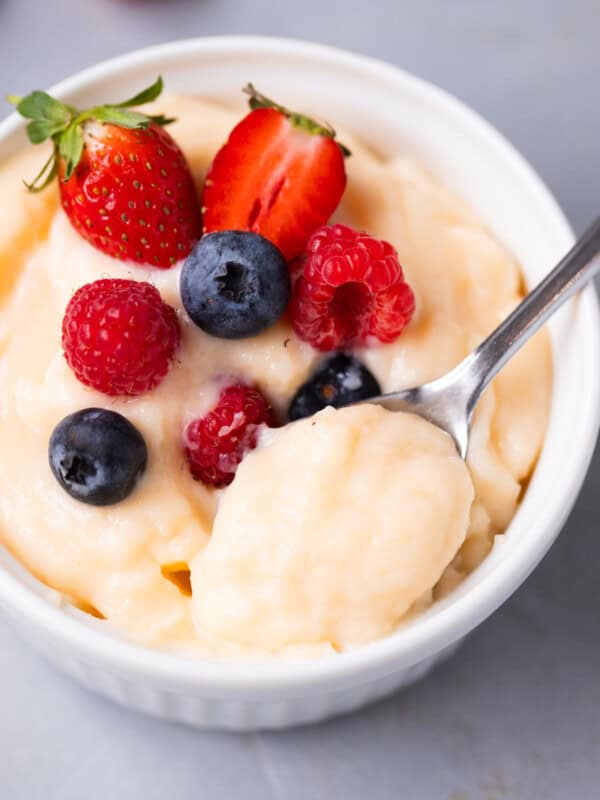 Spoonful of thick vanilla pastry cream showing creamy consistency.