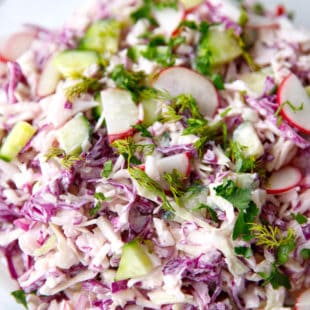 Cabbage salad with radishes in a bowl