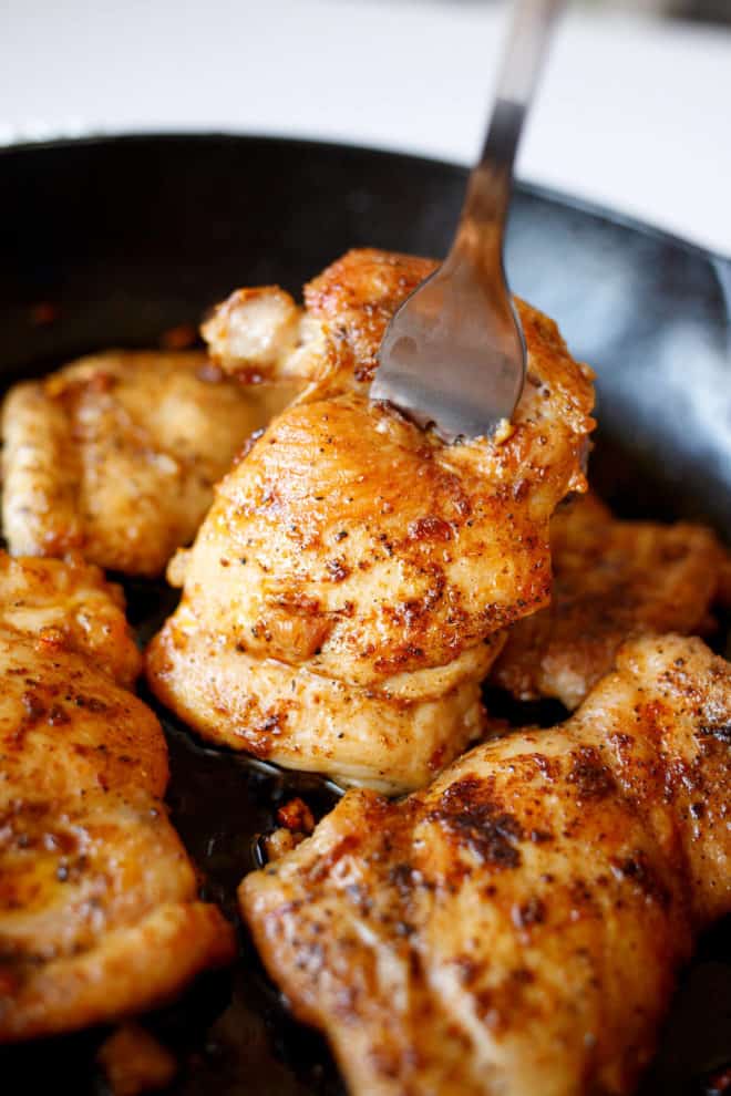 Boneless skinless chicken thighs in a pan