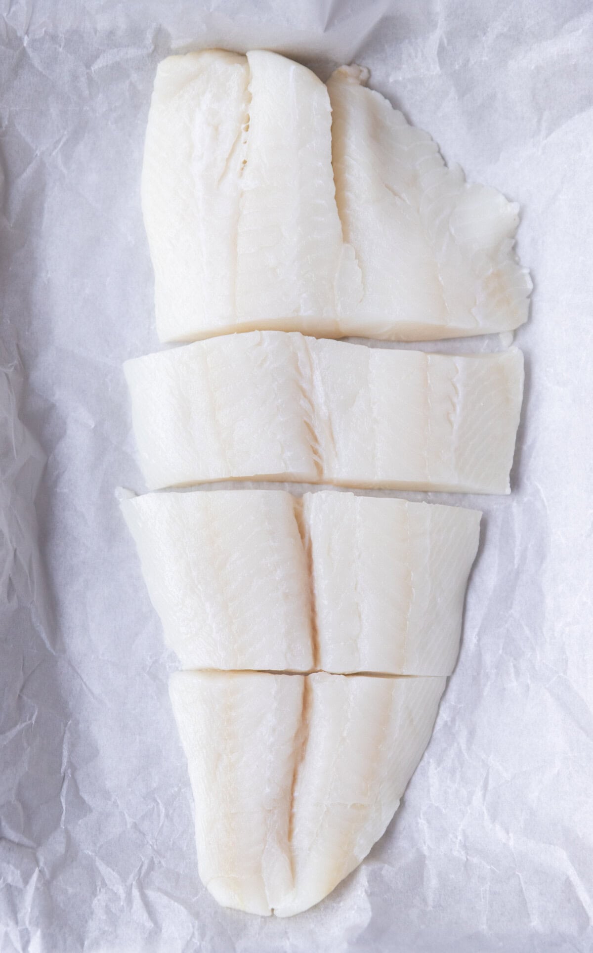 Halibut filet pat dried, sliced into small filets and placed on parchment paper lined baking sheet.