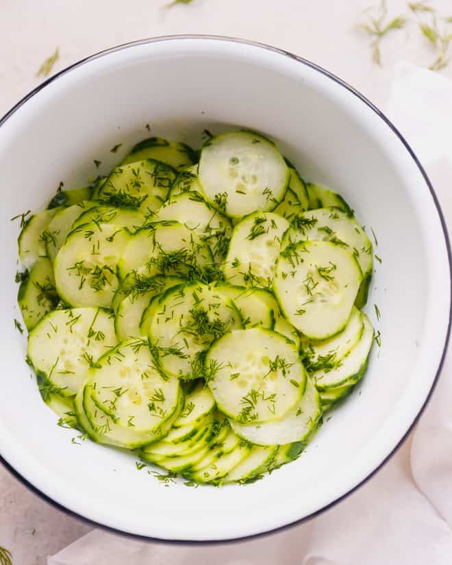 cucumber salad in . white round bowl