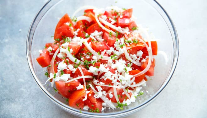 tomato salad in a clear glass bowl
