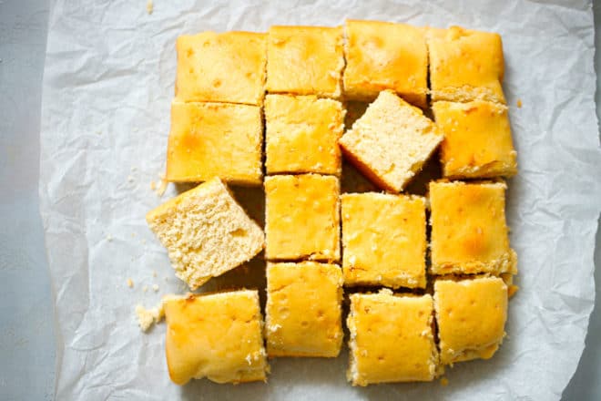 Water cake sliced into squares on parchment paper