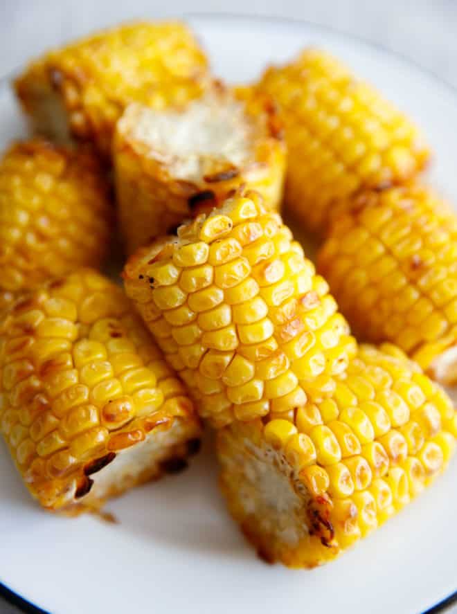 Quarters of corn on the cob cooked in air fryer on a plate